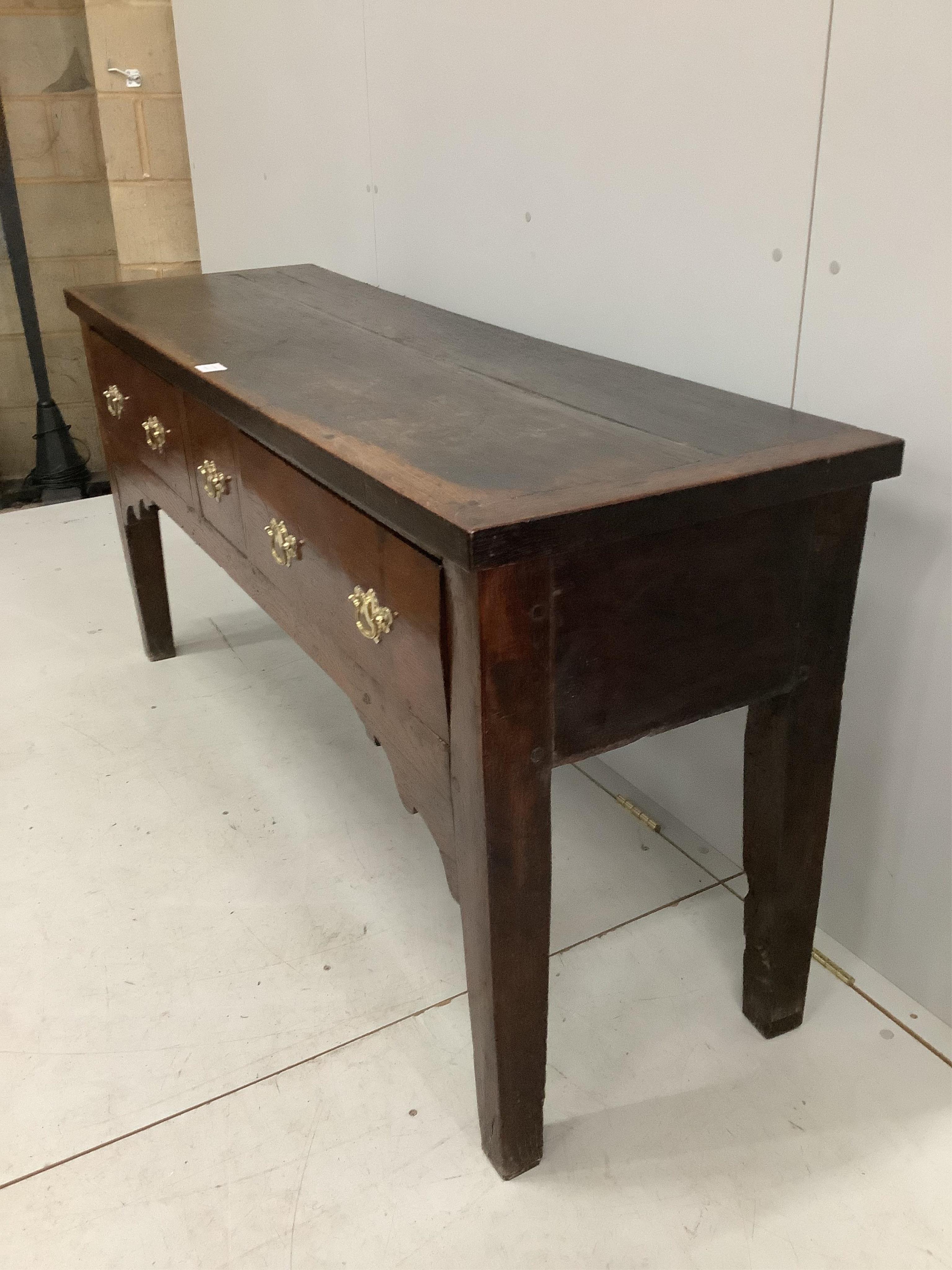 An 18th century style oak low dresser, width 157cm, depth 49cm, height 75cm. Condition - poor to fair